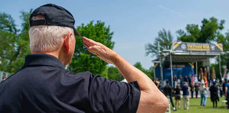 Photo of Vietnam veteran saluting during Welcome Home Opening Ceremony.
